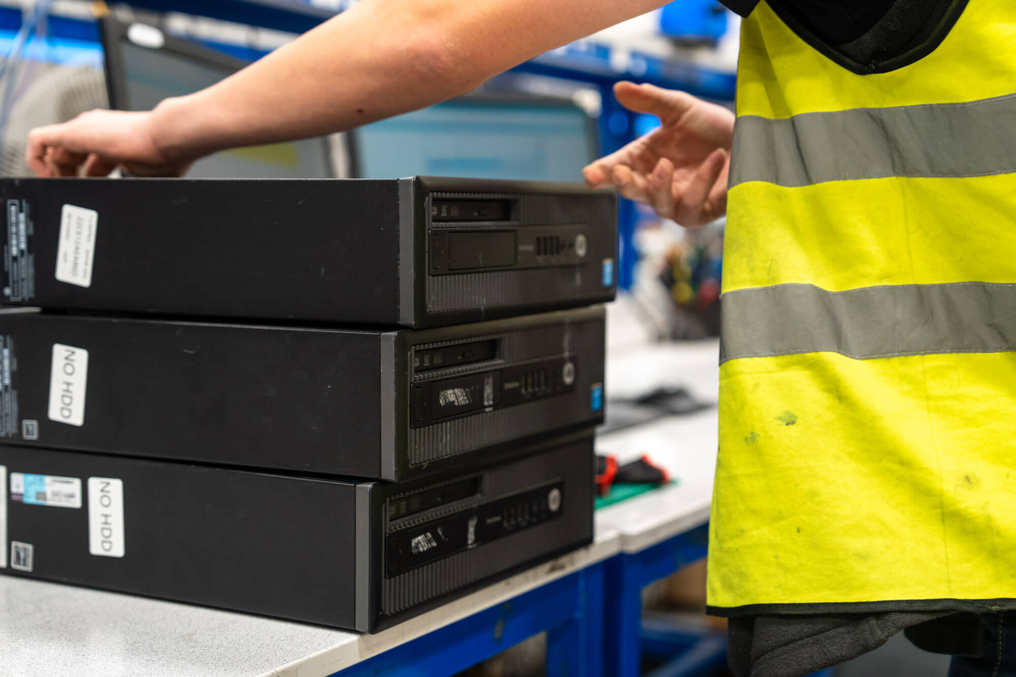 Stack of black computer desktops on a table